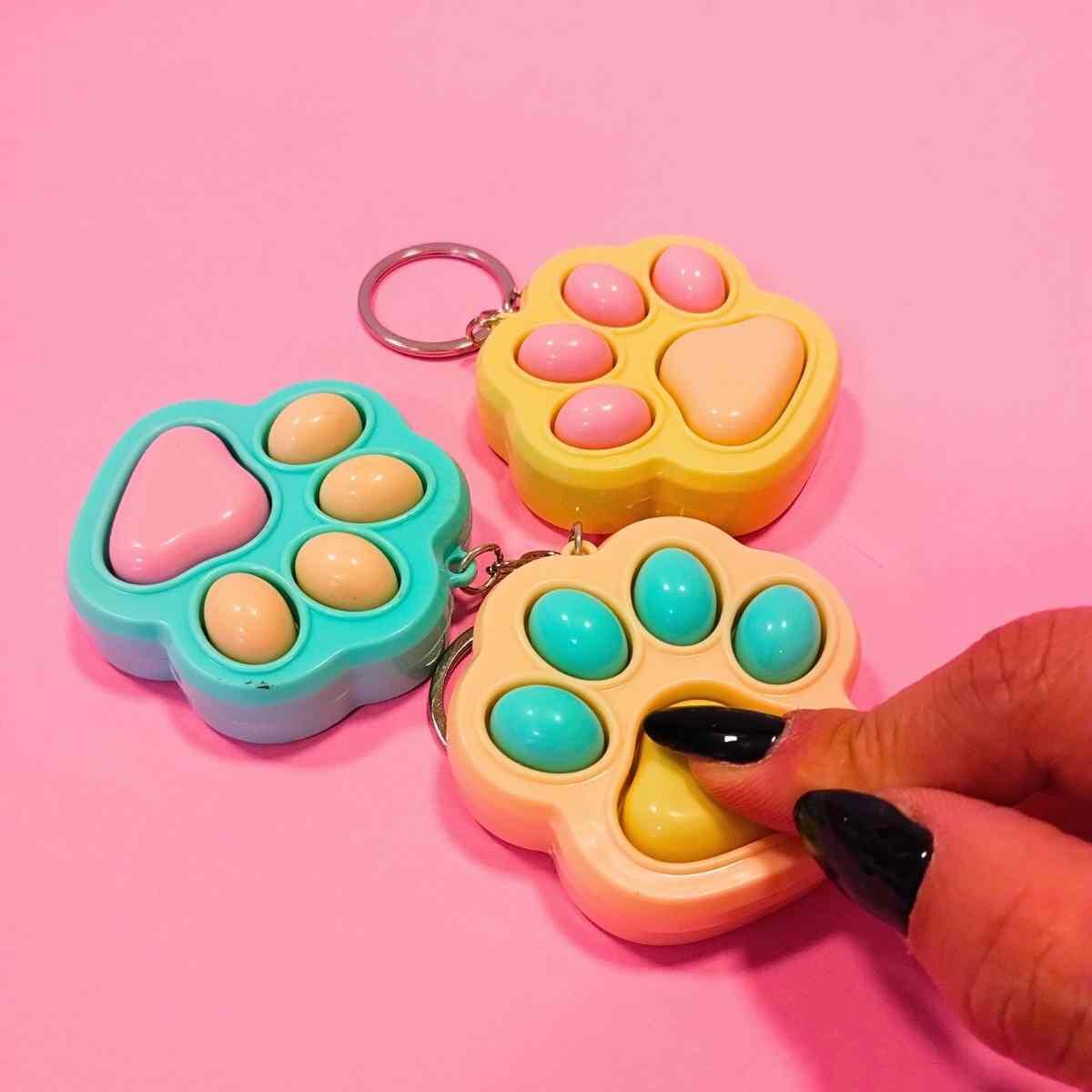 Juego Huellitas pop it y llavero